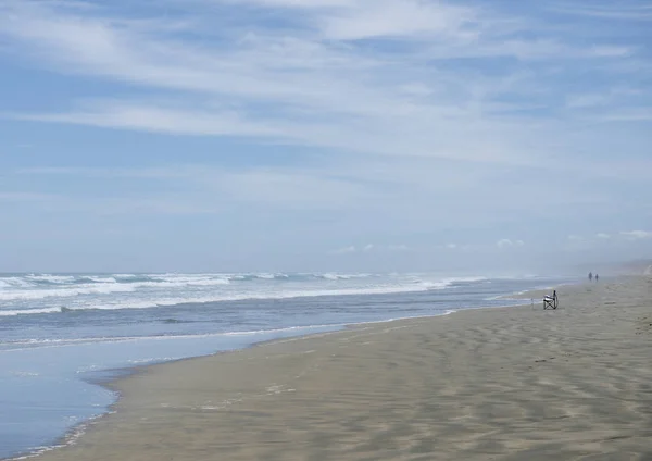 Ninety Mile Beach,North Island New Zealand.People at the beach. Serenity and tranquility at Ninety Mile Beach, wild Coastline in New Zealand.Morning view.Ninety Mile Beach-official New Zealand highway