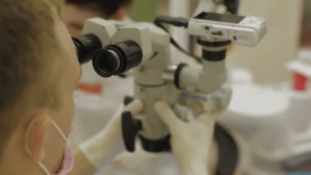 Le dentiste ajuste le microscope — Video