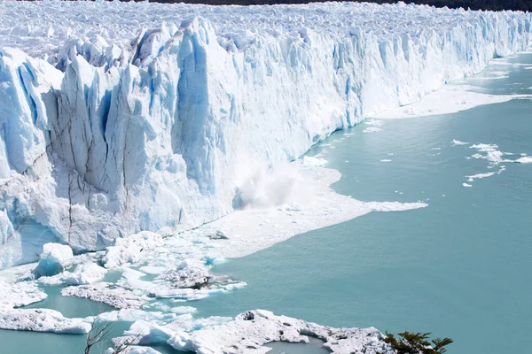 The huge Porito Moreno glacier in Argentina with massive ice carvings smashing into the glacial lake.