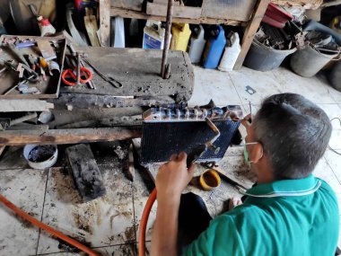 eski arabalarda kırık radyatörleri temizlerken ve tamir ederken radyatör tamircisi. Bir araba atölyesinde, Pekalongan - Jawa Tengah - Endonezya, Haziran 1, 2019