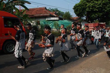 Mahalle sakinleri ve öğrenciler, Yol boyunca yürüyüşler le, İslami okul mezuniyet anma kutluyoruz. Müzik performansları ve bayrak çekme ile Batang / Endonezya, Haziran 22, 2019