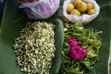 selling various colorful flowers on the street market for religious ceremonies or decorations