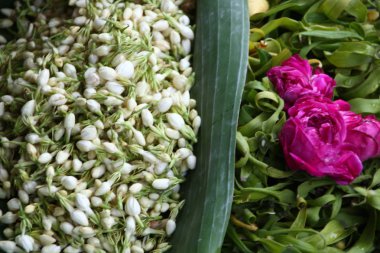 selling various colorful flowers on the street market for religious ceremonies or decorations