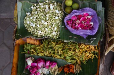 selling various colorful flowers on the street market for religious ceremonies or decorations