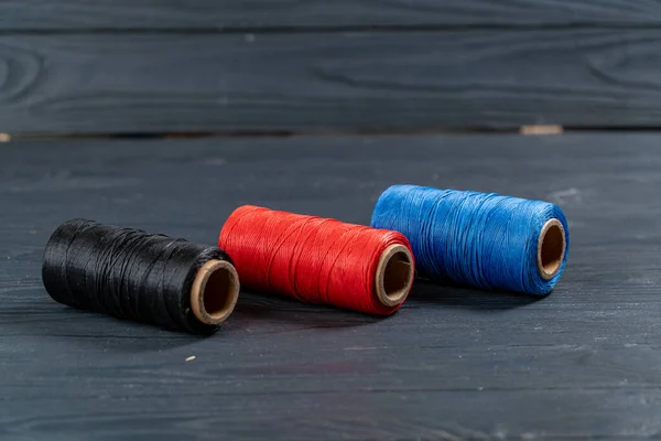Bobinas de hilo negro rojo y azul — Foto de Stock