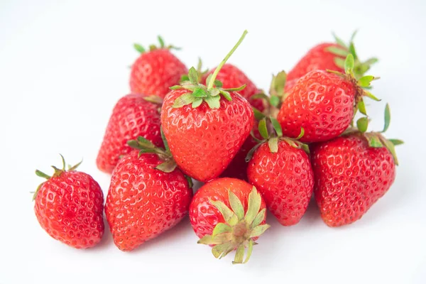 Beyaz arka plandaki parıltıdan birkaç çilek çıkartılır.