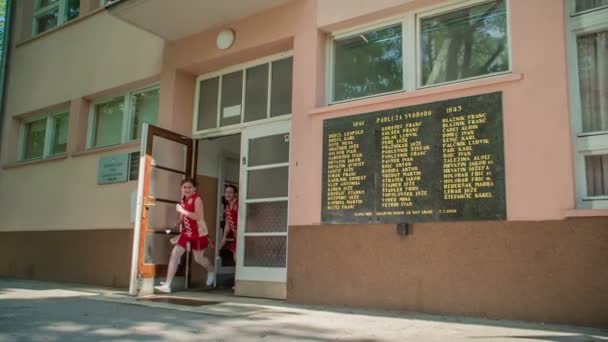 Girls Who Wearing Red Costumes Running Out School Holding Majorette — Stock Video