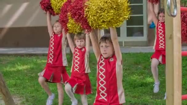 Flickor Utövar Dans Skolgården Håller Röda Och Gula Pom Poms — Stockvideo