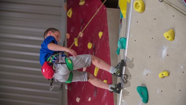 Young Student Slowly Lowers Himself Came Very Top Climbing Wall — Stock Video