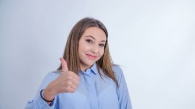 A young model gives thumbs up with one hand first and then another. She looks happy.