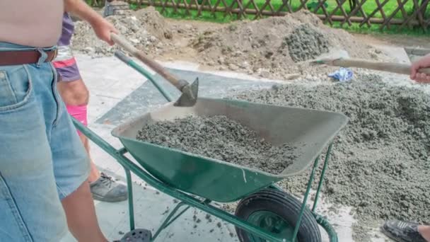 Three Men Mixing Concrete Mixer Water One Shoveling Concrete Mixer — Stock Video