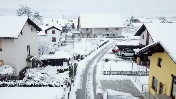 トラックが村を通る小さな道路を走っている 冬の時間で すべてが雪です 航空写真 — ストック動画