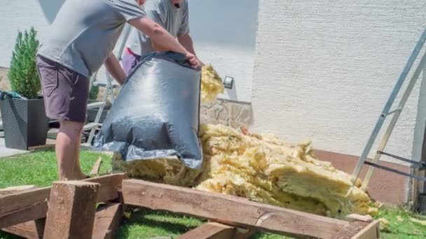 Men Carefully Putting Preserved Glass Wool Black Plastic Bag Younger — Stock Video