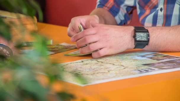 Young Man Points Something Map Finds Brochure Also Shows His — Stock Video