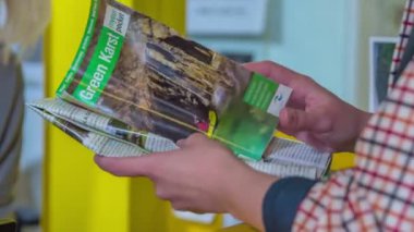 Genç bir adam mağaralar ve Karst bölgesi ile ilgili bir broşürü kontrol ediyor..