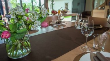 Bir restoranda bir masa ortasında bir buket çiçekle güzelce dekore edilir..