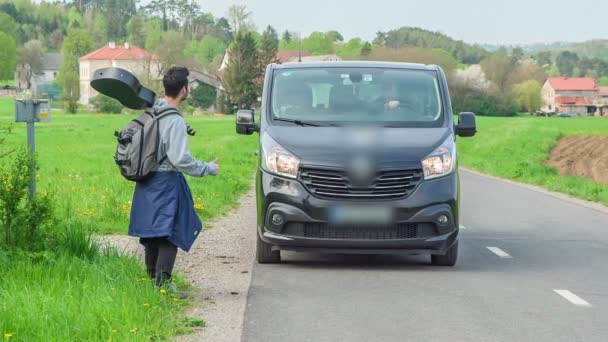 Black Van Stops Side Road Because Young Man Guitar Hitchhiking — Stock Video