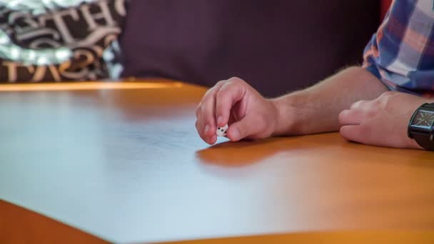 Man Sitting Table Playing White Dice His Hand — Stock Video