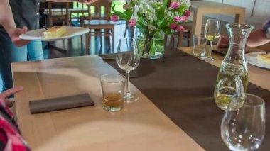 Garsonun biri konukların önüne tatlı koyuyor. Süzme peynirli börek..