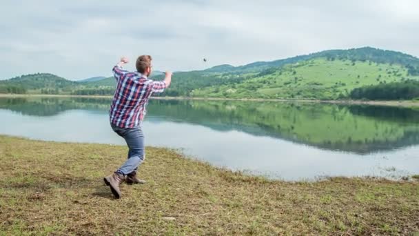 Young Man Trying Throw Stone Very Far Away — Stock Video