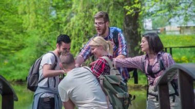 Gençler ellerini birleştirip havaya fırlatıyorlar. Birlikte bir gezide eğleniyorlar..