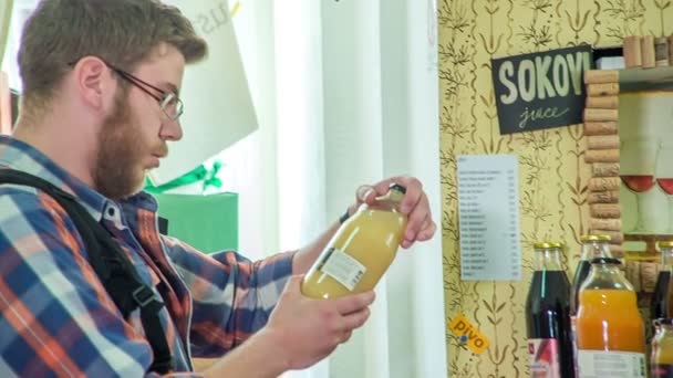 Young Man His Friend Gift Store Checks Out Bottle Juice — Stock Video