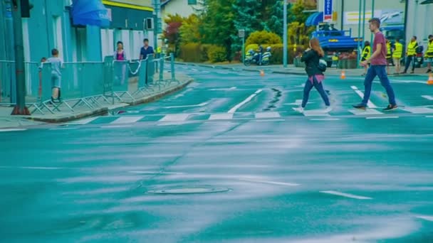 Two Young People Crossing Road Zebra Crossing Roads Wet Slippery — Stock Video