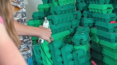 Okul çocukları okulda yumurta kartonundan bir şeyler yapıyorlar. Tüm kutuları yeşile boyamışlar..