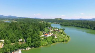 Gölü çevreleyen doğa muhteşemdir. Yaz mevsimindeyiz ve su huzurlu görünüyor..