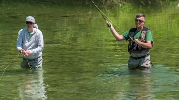 2人の漁師が腰まで水の中にいる 太陽が強すぎるのでサングラスをかけてる — ストック動画