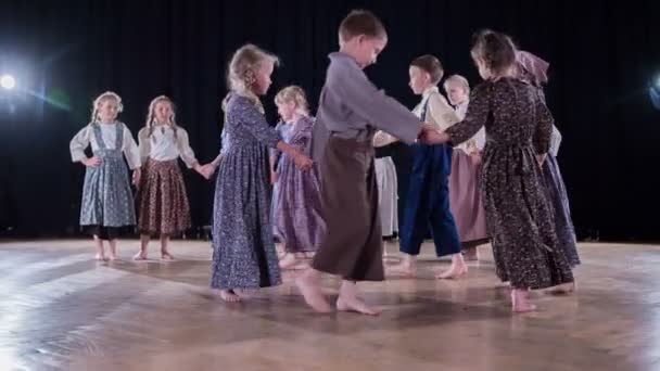 小学生们穿着民族服装 在学校的一场戏中跳舞和表演 — 图库视频影像