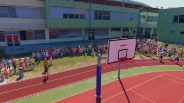 GRIZE, SLOVENIA - 10. Haziran 2017 Çocuklar basketbol sahasında koşmaya başladı. Eğleniyorlar ve farklı spor aktiviteleri yapıyorlar. Yaz mevsimindeyiz. Hava görüntüsü.