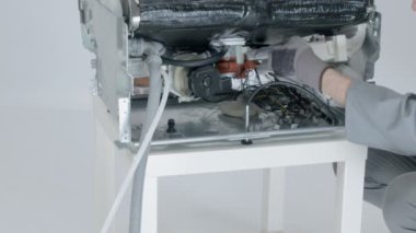 Servis merkezindeki çamaşır makinesinin yakın çekim görüntüleri.