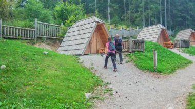 Yürüyüşten dönen bir çift tatillerini geçirirken küçük ahşap evlerine doğru yürüyorlar..