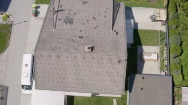 Güzel yeşil bir mahalle. Siyah çatılı büyük bir ev. Kasabada güneşli bir gün..