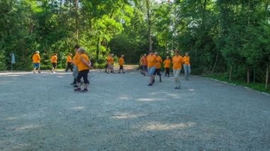 DOMZALE, SLOVENIA - 21. Haziran 2015 'te bir grup insan spor yapıyor. Bu alıştırmada, büyük bir daire çiziyorlar ve elleri arkada..