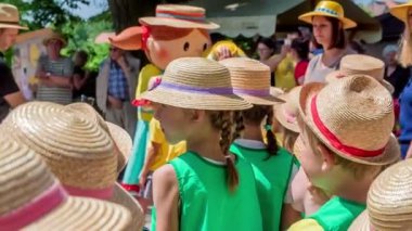 İnsanlar hasır şapka festivalinde eğleniyor.