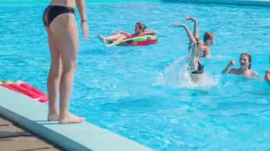 DOMZALE, SLOVENIA - 20. Haziran 2015 'te iki kız havuzun kenarında havalı hareketler sergiliyor. Dans ederek eğleniyorlar..