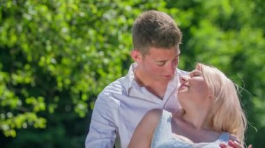 Genç bir çift çimlerin üzerinde dans ediyor, öpüşüyor ve birbirlerinin bedenlerine dokunuyorlar. Dışarıda randevuları var..