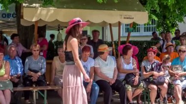 İnsanlar hasır şapka festivalinde eğleniyor.