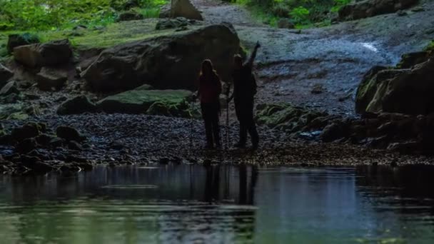 Couple Standing Edge Lake Cave Looking Observing Something — Stock Video