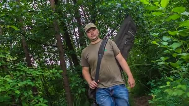 Young Fisherman Walking Forest Noticing Lake — Stock Video