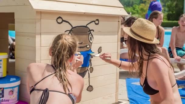 Domzale Slowenien Juni 2015 Zwei Mädchen Malen Einem Holzhaus Neben — Stockvideo