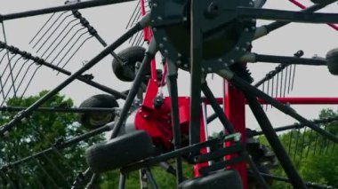 Makinelerin iki tarafının birbirine dokunduğunu görebiliyoruz. Bir çiftçi düğmeye basıyor ve makinenin kenarları yukarı kalkıyor..