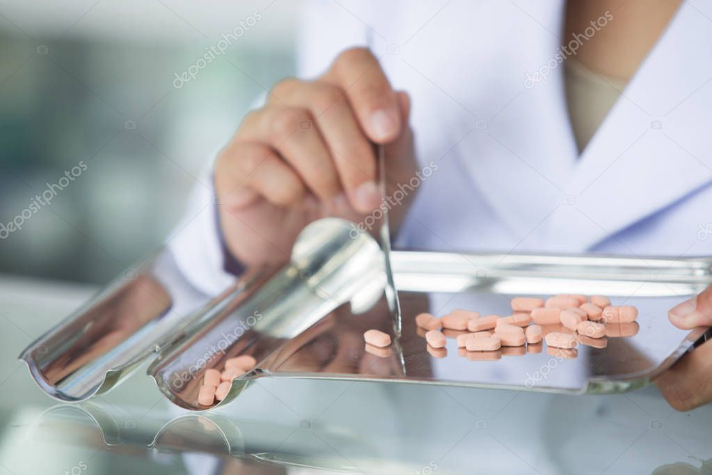 Closeup hand of woman pharmacist with Pills,Drugstore and Pills ,Pharmacists are giving medicines to patients.