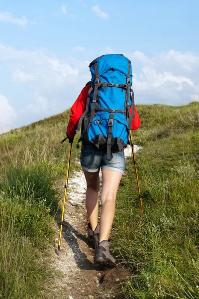Hiking young woman with backpack