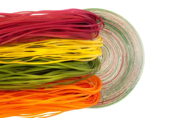 Varicolored pasta with natural vegetable dye in the plate — Fotografia de Stock