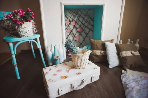 Vintage suitcase in front of fireplace — Stock Fotó