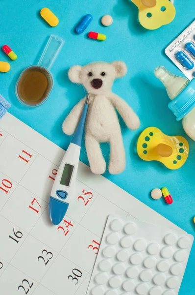 Bear toy with electronic thermometer, pills, nipples and spoon o