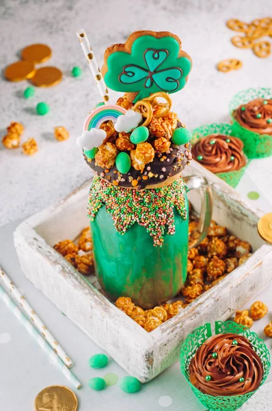 Green freak shake topping with clover cookie in wooden box fille